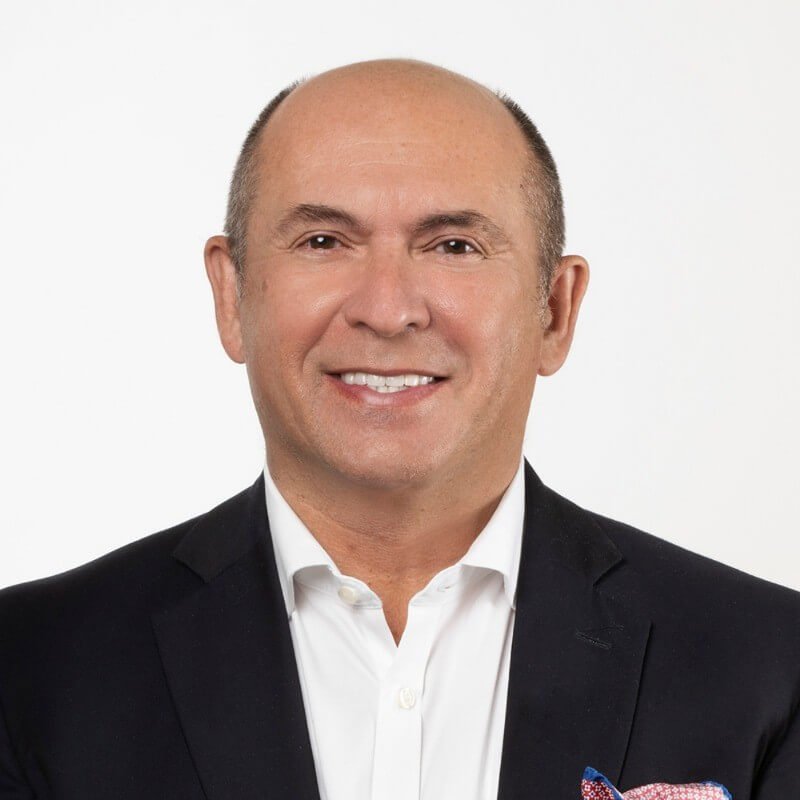 A man smiles directly to camera.